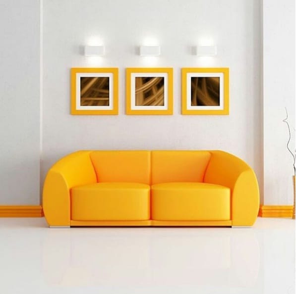 Modern living room with a bright yellow sofa, and stylish decor, creating a warm and inviting atmosphere