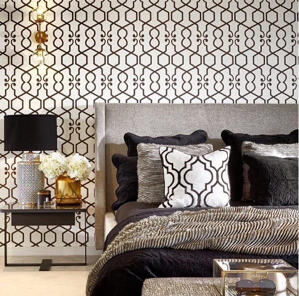 Luxurious golden bedroom with elegant decor, featuring a gold-accented bed, warm lighting, and stylish furnishings